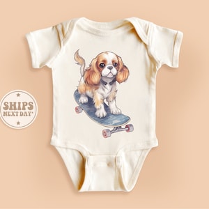 Skater Dog Baby Onesie®, Cavalier King Charles Spaniel Baby Bodysuit, Dog Skateboarding Onesie®, Cute Natural Kid Gift #TLC02435