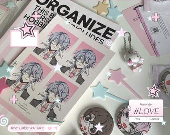 May include: A collection of stationery and accessories in a pastel pink theme. Includes stickers, a Hello Kitty keychain, star-shaped wands, and a notepad with anime-style character illustrations. The text "ORGANIZE" is visible on a notepad.