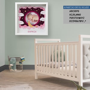 May include: A framed baby birth announcement with a circular photo of a sleeping infant. The frame is white, with pink and purple cloud and star cutouts. The baby's name, "SOPHIA", is displayed below the photo. Measurements are in centimeters.