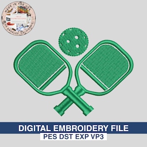 May include: Green embroidered pickleball paddles and ball design. The paddles are crossed, and the ball is above them. The text "DIGITAL EMBROIDERY FILE" is at the bottom. The image also includes the text "MADE IN THE USA".