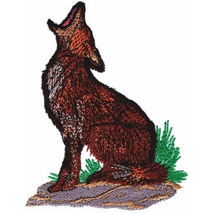 May include: An embroidered patch featuring a howling wolf in shades of brown, black, and white. The wolf is sitting on a rock with green foliage. The patch has a detailed, textured appearance, suitable for apparel or crafts.