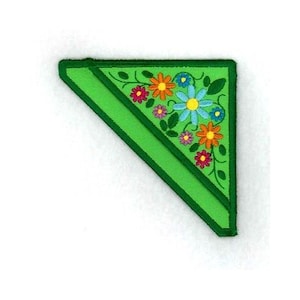 May include: Green fabric triangle bookmark with a floral design featuring colorful flowers and leaves.