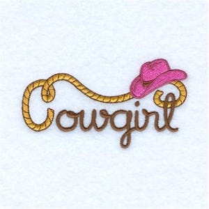 May include: Embroidered design of the word "cowgirl" in brown with a gold rope design and a pink cowboy hat on top.