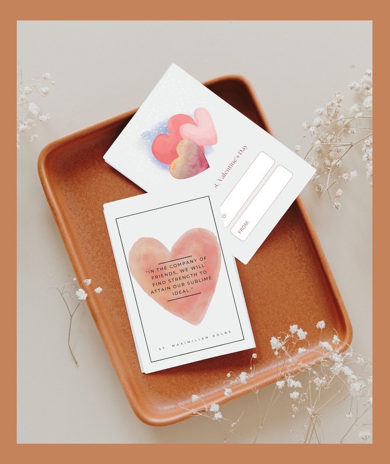 May include: Two Valentine's Day cards with watercolor hearts. One card has a quote by St. Maximilian Kolbe: "In the company of friends, we will find strength to attain our sublime ideal."