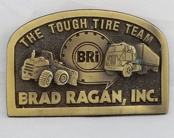 Vintage Brass Brad Ragan Inc. Belt Buckle: The Tough Tire Team