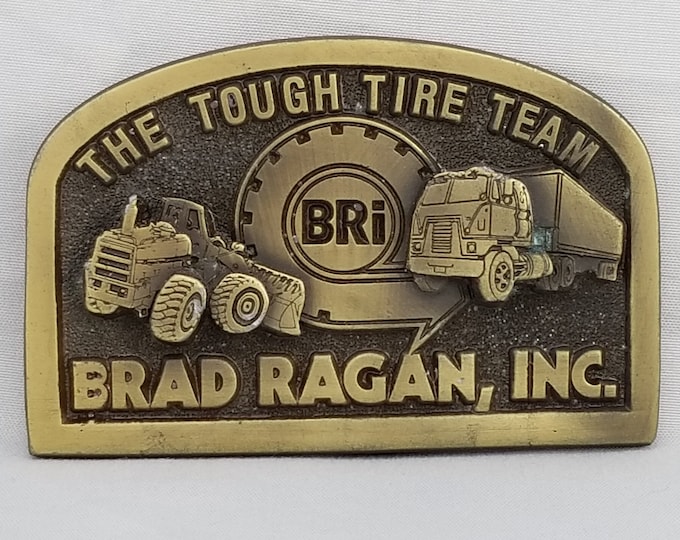 Vintage Brass Brad Ragan Inc. Belt Buckle: The Tough Tire Team