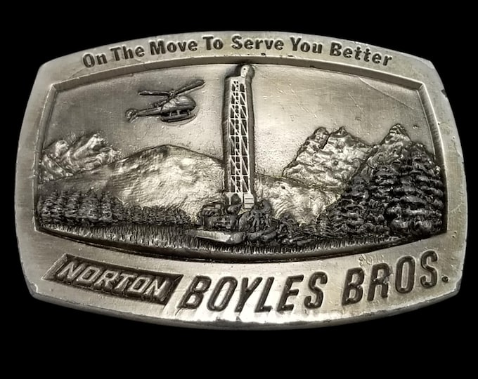 Amwest Casting Belt Buckle - Norton Boyles Bros Collectible with Mountain Scene