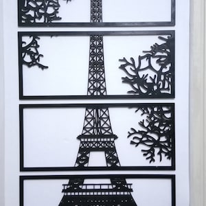 May include: A black laser-cut MDF wall art piece depicting the Eiffel Tower in Paris, France. The tower is shown in four sections, with a tree design on either side of the tower in each section. The text "3mm mdf laser cutting result" is at the bottom of the image.