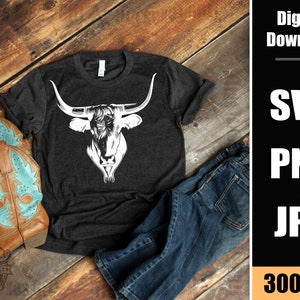 May include: A dark gray t-shirt with a white silhouette of a longhorn bull's head. The t-shirt is laying on a wooden surface with a pair of blue jeans and brown cowboy boots.