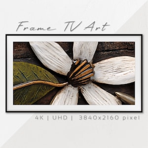 May include: A close-up of a white flower with a gold center, carved in wood. The flower is set against a dark brown wood background. The image is labeled "4K | UHD | 3840x2160 pixel".