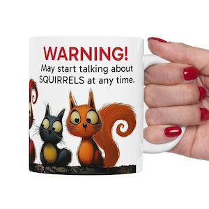 May include: White ceramic mug with a red warning sign that says "WARNING! May start talking about SQUIRRELS at any time." The mug features a cartoon illustration of three squirrels.