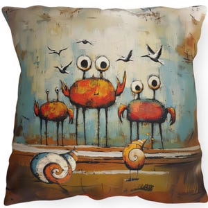 May include: Square throw pillow featuring an artistic illustration of whimsical crabs and snails. The crabs are orange with large, googly eyes and long legs. The snails are white and orange with spiral shells. The background is a blend of blue, brown, and white.