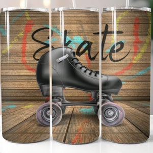 May include: A black roller skate with white wheels on a wooden background with colorful paint splatters. The word "Skate" is written in white on the background.
