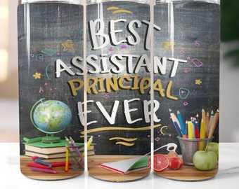 May include: A black and white tumbler with the text "BEST ASSISTANT PRINCIPAL EVER" written in colourful letters on a chalkboard background. The tumbler is surrounded by school supplies, including a globe, pencils, books, and an apple.