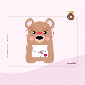 May include: A brown bear wearing pink glasses holds a white gift box with a pink heart and the word "lover" written on it. The bear has pink cheeks and a black nose. A chocolate donut with sprinkles and a halo is in the upper right corner of the image.