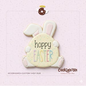 May include: A bunny-shaped cookie with the words "hoppy EASTER" in pastel colors. The cookie has a light yellow base with sprinkles and white and pink accents. A small donut with wings and a halo is at the top.