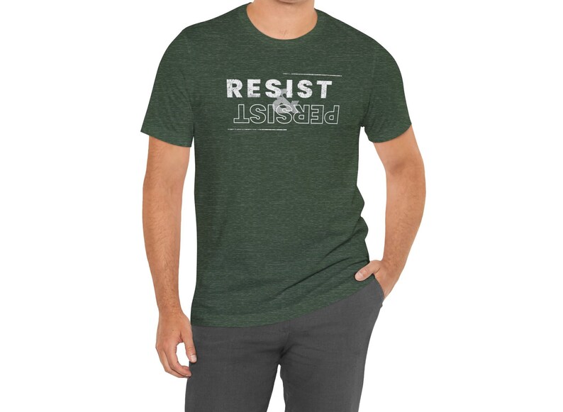 May include: A dark green t-shirt with a white graphic that reads "Resist & Persist".
