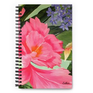 May include: A pink and orange flower with green leaves and purple flowers in the background. The image is signed "Esther" in the bottom right corner.