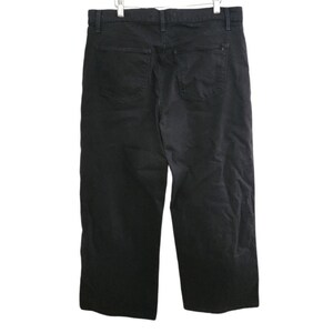 May include: Black denim pants with two back pockets. The pants are hanging on a white background. The pants have a classic five-pocket design and a straight leg cut.