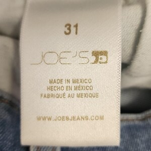 May include: A close-up of a white tag with the number 31 in a bold font. The tag features the brand name "JOE'S" and the text "MADE IN MEXICO" in English, Spanish, and French. The website address is also visible.