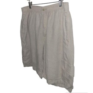 May include: Beige linen shorts with a drawstring waist and two large cargo pockets on each side.