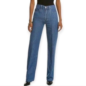 May include: High-waisted blue denim jeans featuring a straight-leg cut, a classic button and zip fly closure, and a clean, solid medium-wash finish. The trousers are designed with a structured waistband and visible vertical seam detailing.