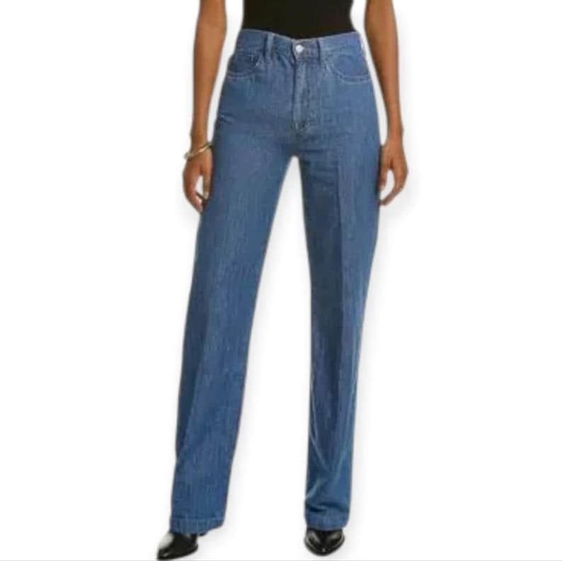 May include: High-waisted blue denim jeans featuring a straight-leg cut, a classic button and zip fly closure, and a clean, solid medium-wash finish. The trousers are designed with a structured waistband and visible vertical seam detailing.