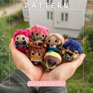 May include: Six small, round, crocheted amigurumi dolls with black bead eyes, featuring various hair colors including pink, brown, blonde, and blue. The dolls are arranged together, with the text "PATTERN" at the top and "CHICKURIMI" at the bottom.