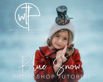 May include: A young girl wearing a red coat with a black and white plaid collar, a white fur hat with a black top hat, and a white fur trim. The girl is smiling and holding her hands together in front of her. The background is a blue and white snowy scene. The text "Blue Snow Photoshop Tutorial" is written in white cursive script below the girl.