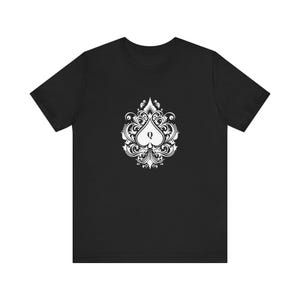 May include: Black t-shirt with a white graphic of a stylized queen of spades playing card symbol.