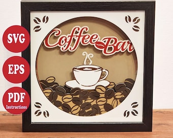 May include: A black framed shadow box with a white background and a brown circle in the center. The circle features the text "Coffee Bar" in red and white lettering with a stylized steam design above a white coffee cup with brown coffee inside. The coffee cup is sitting on a white saucer on top of a bed of brown coffee beans.