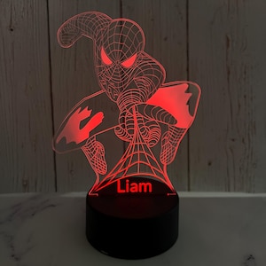 May include: Red 3D printed night light featuring a Spiderman design with a web and the name "Liam" printed below.