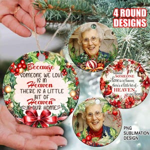 May include: Four round Christmas ornament designs featuring a wreath with red berries and a red bow. The ornaments have a white background with the text "Because someone we love is in heaven there is a little bit of heaven in our home". Each ornament has a photo of a woman in the center.