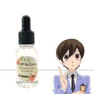 May include: A clear glass bottle with a black dropper top, labeled "Fall In Love Rosemary & Vanilla Essential Oils." The bottle contains 15ml of essential oils. A cartoon character is to the right of the bottle.