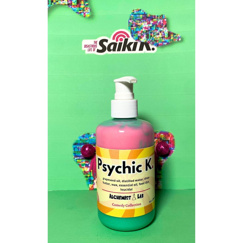 May include: A colorful bottle of Psychic K. lotion with a white pump dispenser. The bottle is pink and green with the text "Psychic K." and "Alchemist Lab Comedy Collection." The background is green with decorative shapes.