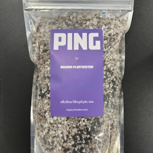 May include: A clear, resealable plastic pouch filled with a granular alkaline lithophytic mix for tropical butterworts. A purple label on the front features the white text PING, by BOGMAN PLANTENSTEIN, alkaline lithophytic mix, tropical butterworts.