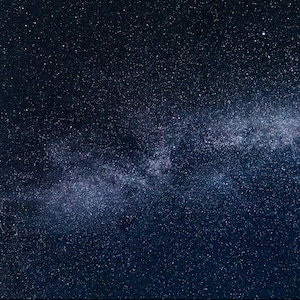 May include: A dark blue night sky with a band of white stars, the Milky Way, stretching across the image.