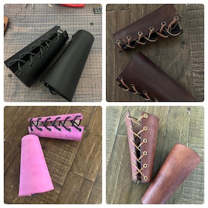 Handmade leather bracers in black, brown, pink, and natural leather with lace-up designs. Ideal for cosplay, Renaissance fairs, and medieval reenactments. Crafted from real leather in various finishes, perfect for costume or role-playing