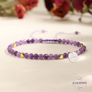 May include: A purple amethyst beaded bracelet with gold accents and a silver charm that says "Josephine".