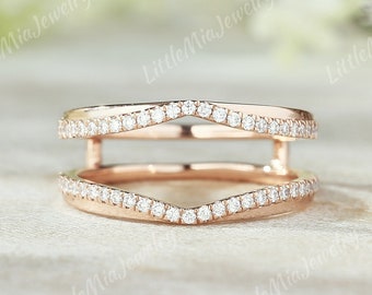 Puede incluir: Un anillo de oro rosa con un diseño de doble banda. La banda superior es una forma delicada y curvada con pequeños diamantes engastados en pavé. La banda inferior es una banda recta con pequeños diamantes engastados en pavé.
