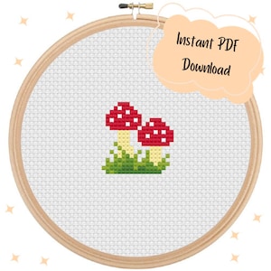 May include: Cross stitch pattern featuring two red and white mushrooms with white spots, surrounded by green grass.  Instant PDF Download.
