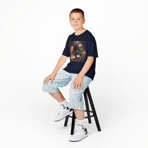 May include: A navy blue short-sleeve t-shirt featuring a graphic print of a human character and a helmeted bounty hunter character holding mugs of beer. The shirt has a crew neckline and a standard fit, showcasing a detailed, colorful illustration.