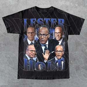 May include: Black t-shirt with a graphic print of Lester Holt and other men. The graphic is in a retro style with a blue and white color scheme. The text "Lester Holt" is printed in large white letters.