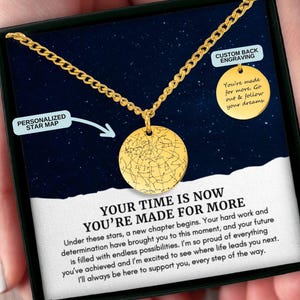 May include: A gold necklace with a round pendant featuring a personalized star map. The necklace comes in a black box with a message that reads "Your time is now, you're made for more."
