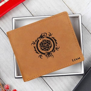 May include: A brown leather wallet with a black dragon and a 20-sided die design. The wallet is personalized with the name "LIAM".