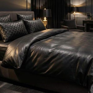 May include: A luxurious black leather bed set, featuring a comforter, fitted sheet, and quilted pillow shams. The bedding is arranged on a dark gray bed frame, creating a sophisticated and elegant bedroom aesthetic. The room is dimly lit, with lamps providing soft illumination.