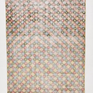 May include: Rectangular rug with a diamond pattern in shades of red, blue, green, and yellow. The rug has a distressed, vintage look. The dimensions are 5.5 feet by 4.1 feet.
