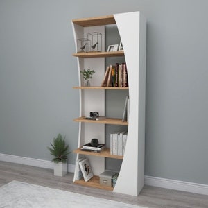 May include: A white and wood bookshelf with five shelves. The shelves are curved and have a modern design. The bookshelf is filled with books, plants, and decorative items.