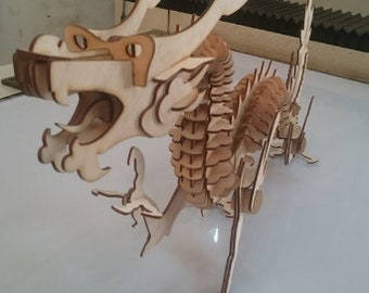 May include: A wooden dragon model kit, assembled and ready to display. The dragon is made of light brown wood and has a detailed design. The dragon is standing on its hind legs with its wings spread out.