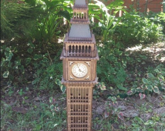 May include: A wooden model of Big Ben, the famous clock tower in London, England. The model is detailed and includes a clock face with Roman numerals.